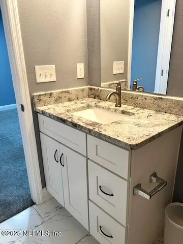 a kitchen with a sink appliances and cabinets