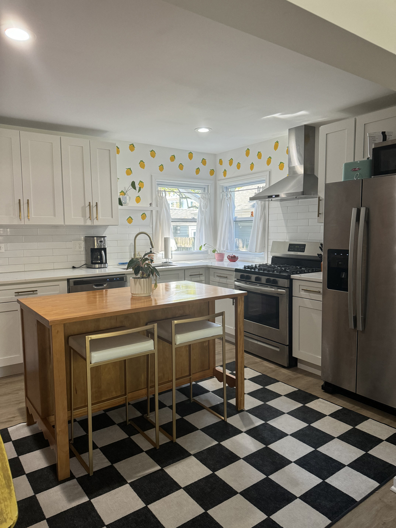 644 West Hinsdale Avenue Hinsdale, IL 60521 - Photo 3 of 17 a kitchen with a checkered floor and white cabinets