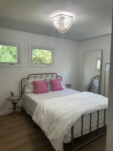 a bedroom with a bed and a chandelier