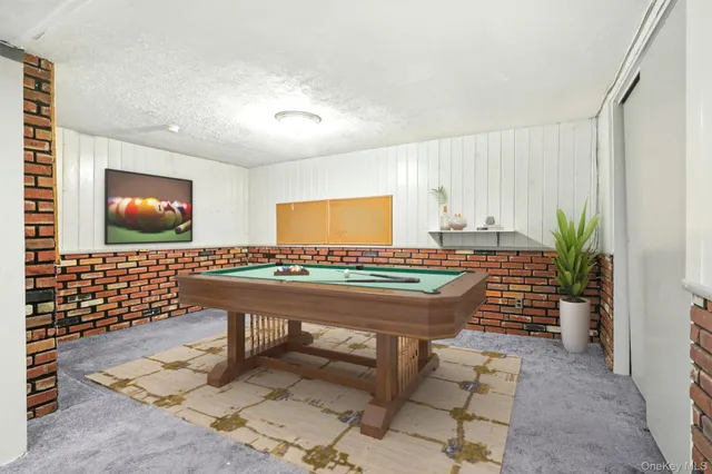 a room with furniture pool table and window