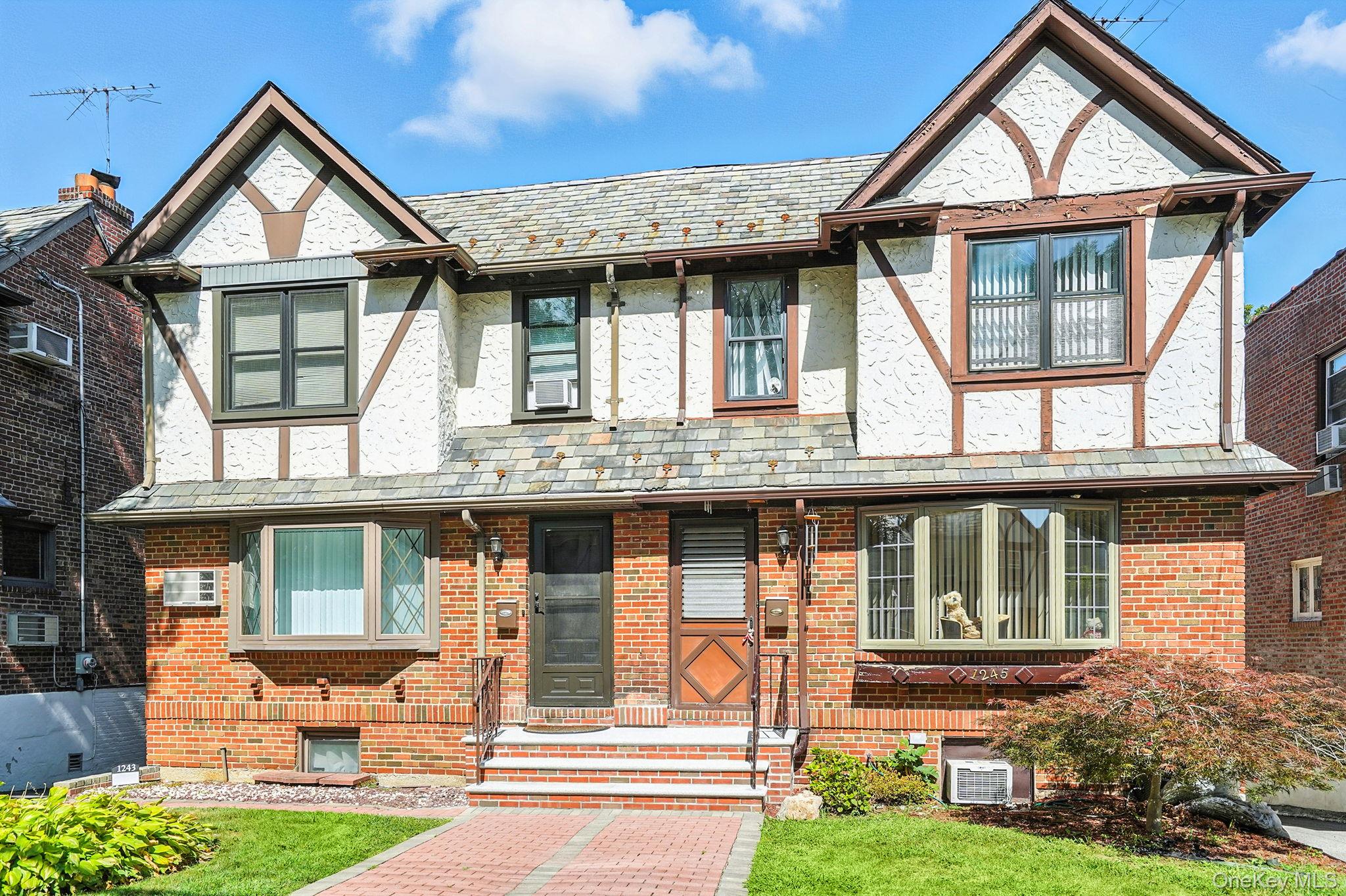 1245 Rhinelander Avenue Bronx, NY 10461 - Photo 30 of 34 Tudor house with a high end roof, stucco siding, and brick siding