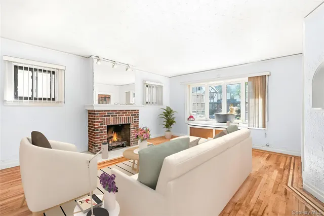 a living room with furniture a fireplace and a floor to ceiling window