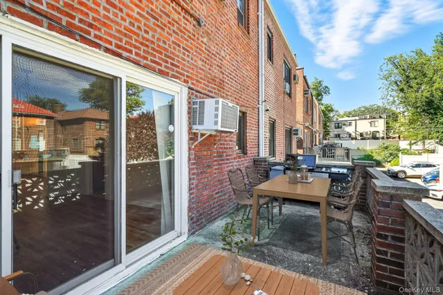 a view of a patio with couches and table and chairs and potted plants