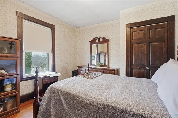 a bedroom with a bed and a window