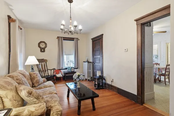 a living room with furniture and a chandelier
