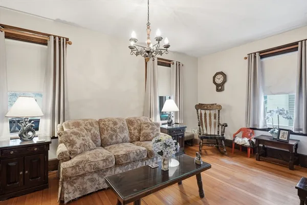 a living room with furniture a table and a chandelier