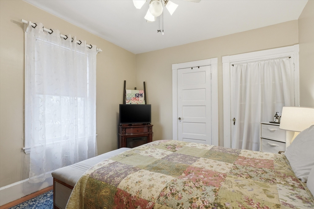 24 Fairview Avenue Swampscott, MA 01907 - Photo 19 of 39 a bedroom with a bed and a flat tv screen in it