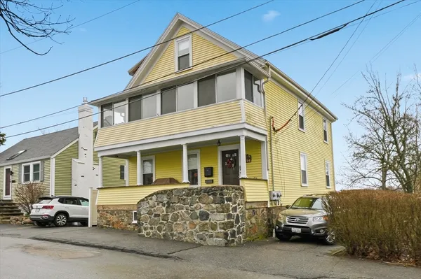 a couple of cars parked in front of a house