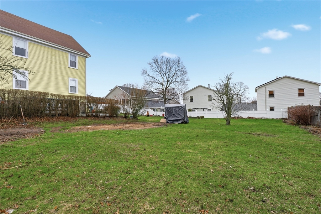 24 Fairview Avenue Swampscott, MA 01907 - Photo 30 of 39 a view of a white house with a big yard plants and large tree