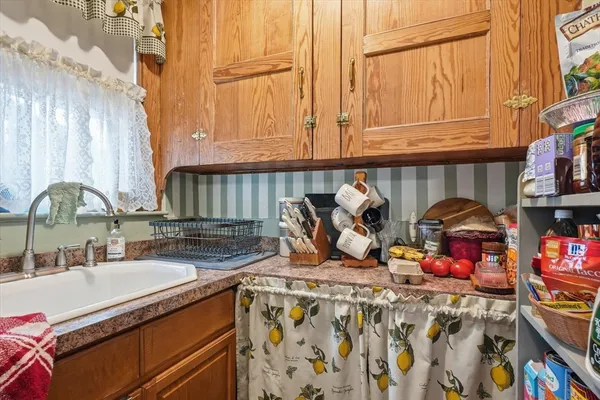 a kitchen with stainless steel appliances granite countertop a sink a stove and a microwave