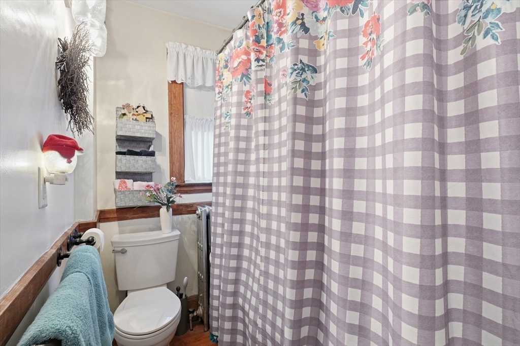 24 Fairview Avenue Swampscott, MA 01907 - Photo 9 of 39 a white toilet sitting next to a shower curtain
