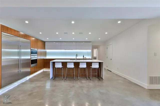a view of a kitchen with dining room and window