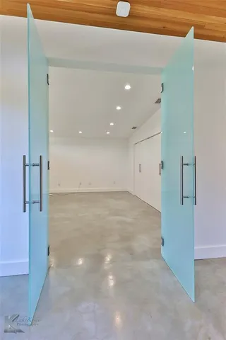 an empty room with windows and closet