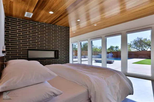 a bedroom with a bed and a night stand