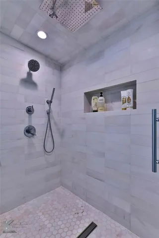 a bathroom with a tub sink and mirror