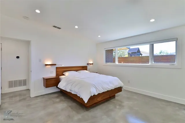 a bedroom with a bed and a night stand