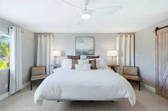 a bedroom with a bed tv and window