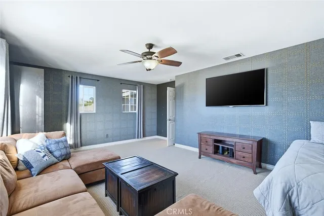 a bed sitting in a spacious bedroom next to a window