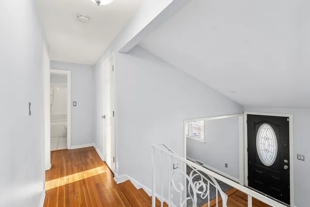 a view of an entryway with wooden floor