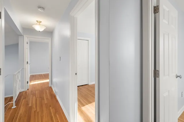 a view of hallway with wooden floor