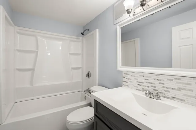 a bathroom with a sink a toilet and a bathtub