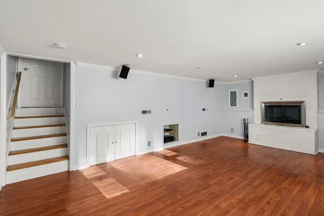 a big room with wooden floor and windows