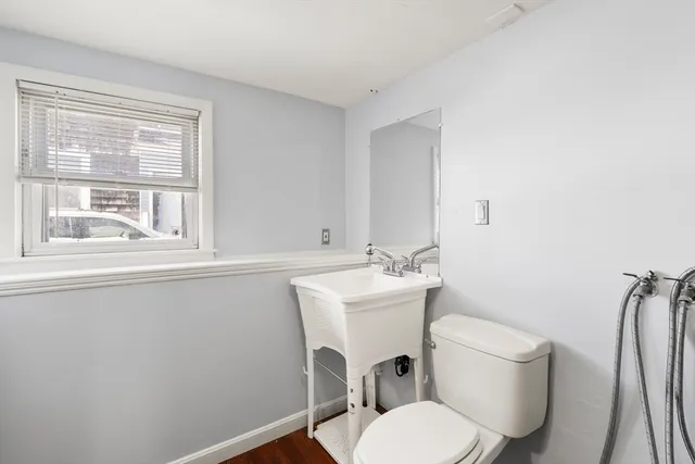 a white toilet sitting next to a bathroom sink