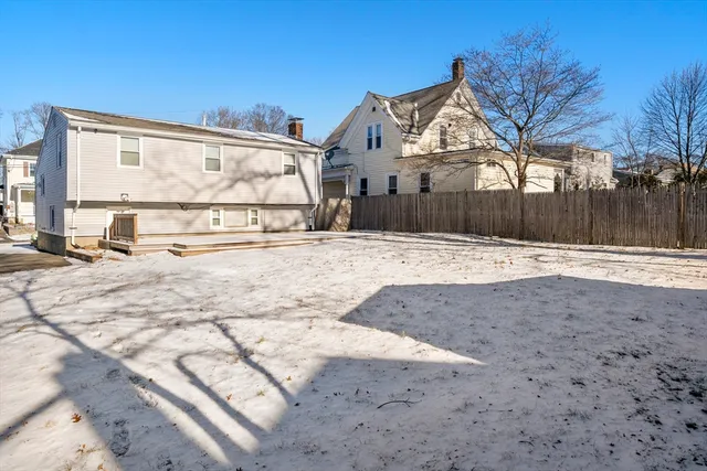 a view of a house with snow on the road