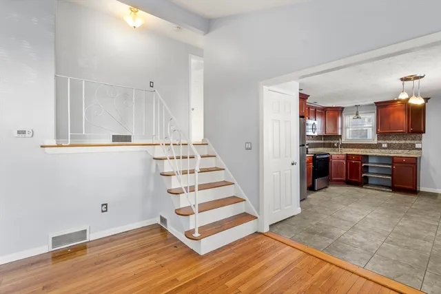 a view of a kitchen with wooden floor and electronic appliances