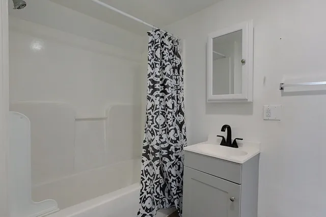 a bathroom with a bathtub and a sink