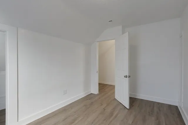 a view of a room with wooden floor