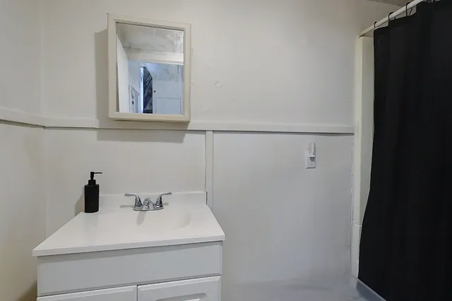 a bathroom with a sink and mirror