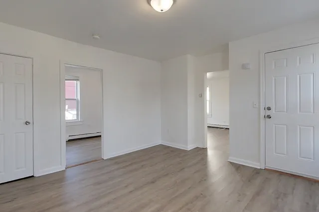 a view of a hallway with wooden floor