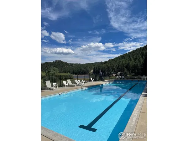 a view of a patio with dining table and chairs with a floor to ceiling window
