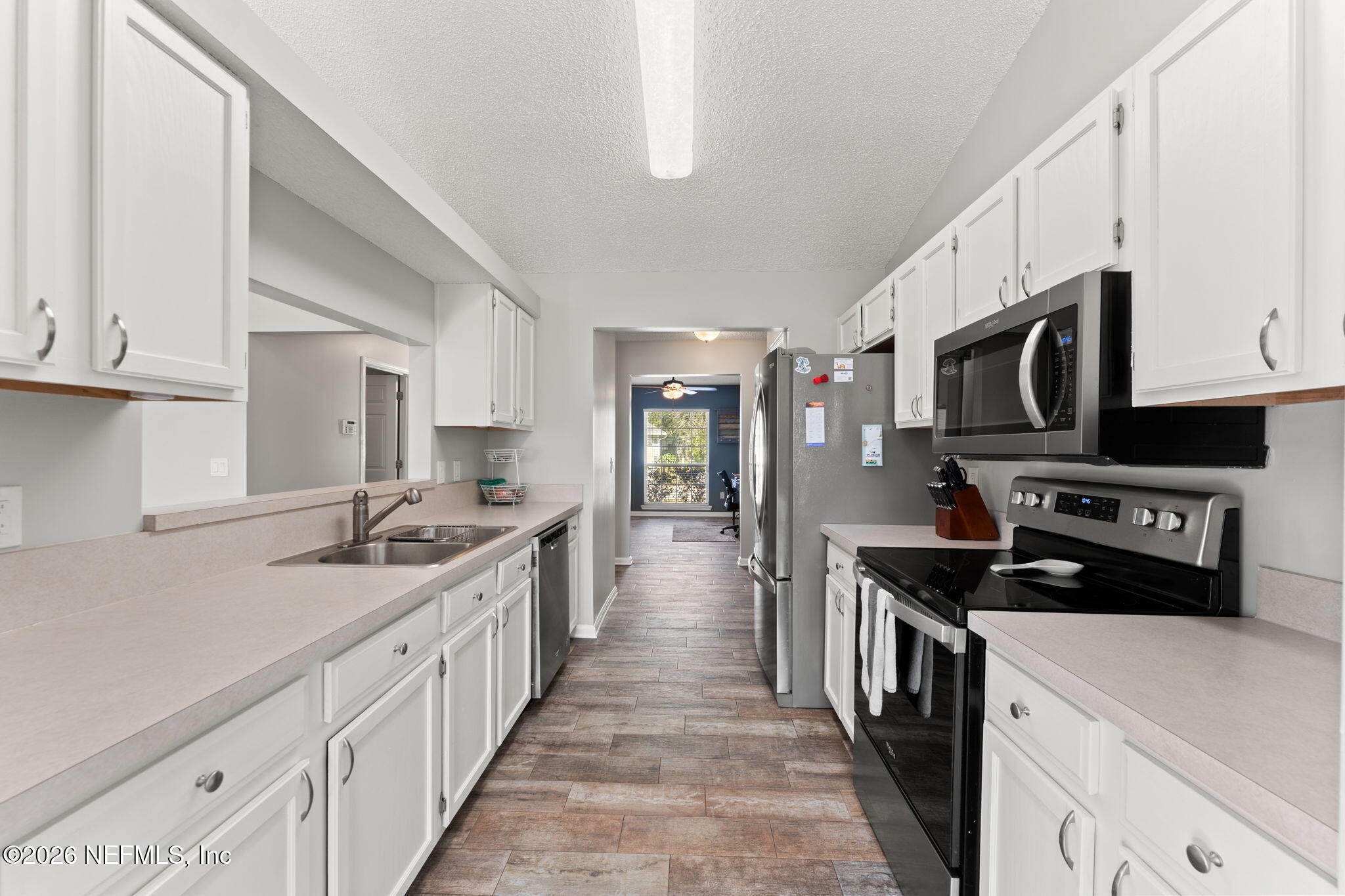 2982 Chief Ridaught Trail Middleburg, FL 32068 - Photo 5 of 29 a kitchen with stainless steel appliances a sink stove top oven and cabinets
