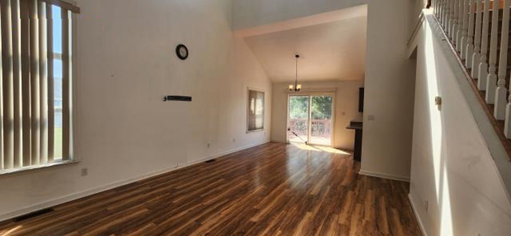 2402 Octopus Road Greenbackville, VA 23356 - Photo 3 of 21 a view of an empty room with wooden floor and a window