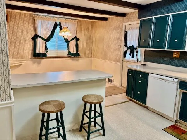 a kitchen with stainless steel appliances a sink and a refrigerator