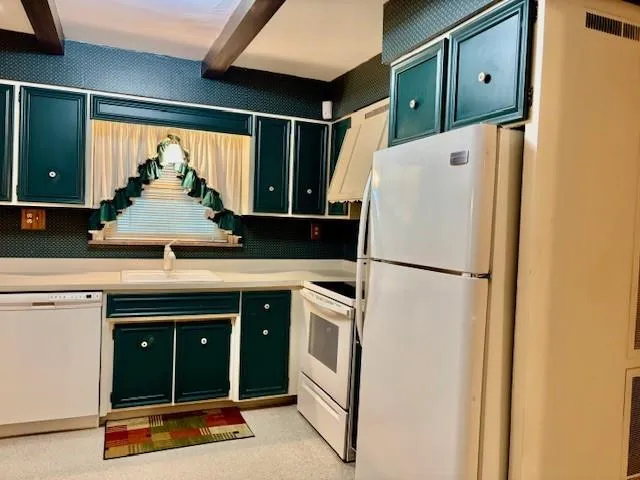 a kitchen with a refrigerator and a sink