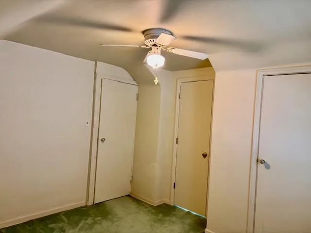 a view of a room with a window and a ceiling fan