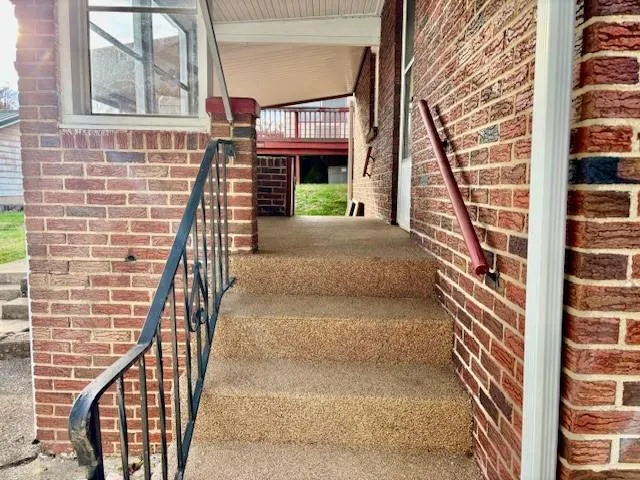 a view of a house with a yard and sitting area