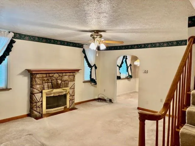 a view of a livingroom with furniture and a fireplace
