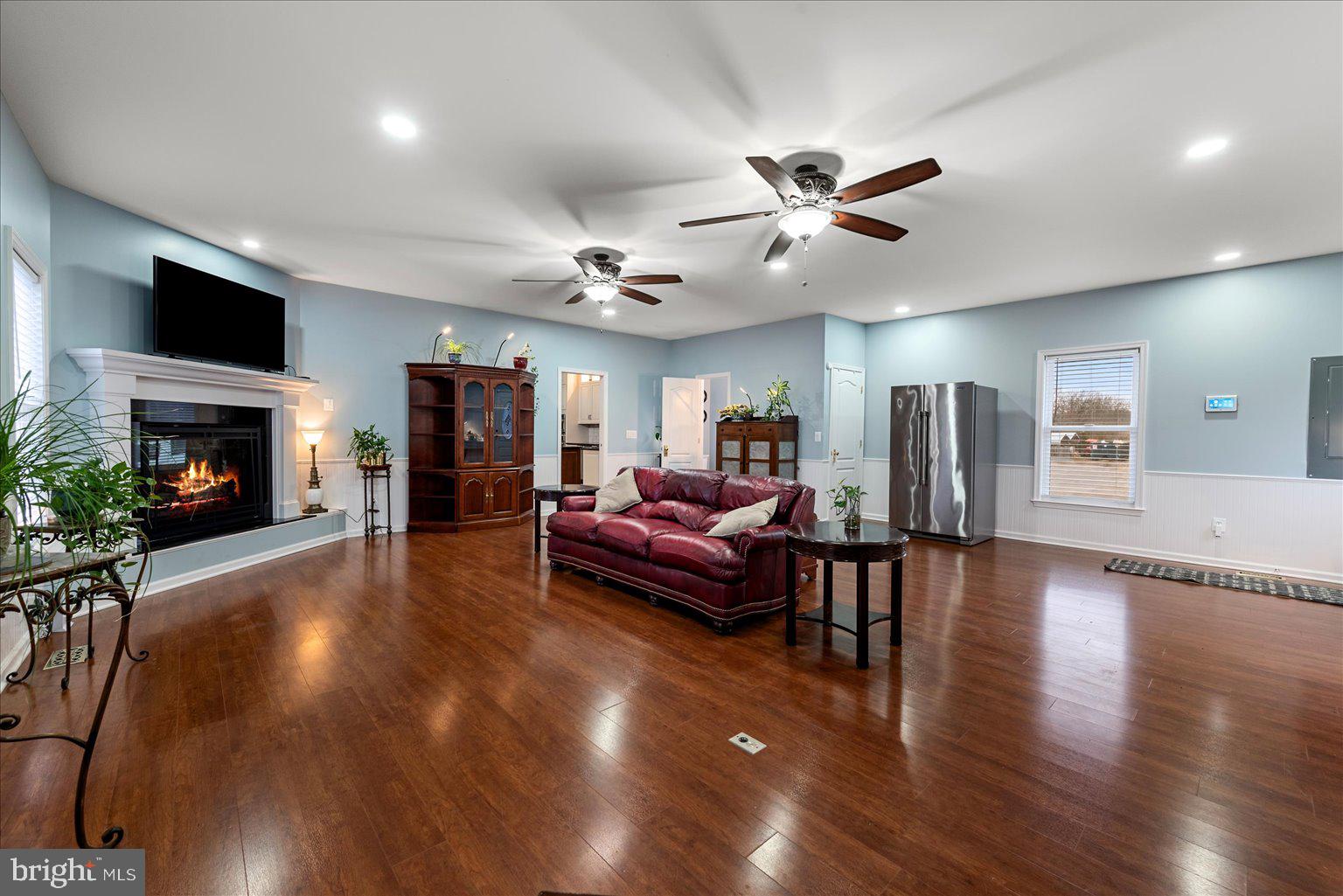 978 Old Charles Town Road Berryville, VA 22611 - Photo 13 of 31 a living room with furniture a fireplace and a flat screen tv