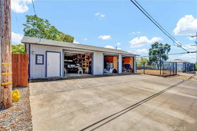 a view of a house with a patio and a yard