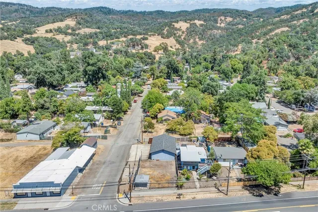 an aerial view of residential houses with outdoor space and ocean view