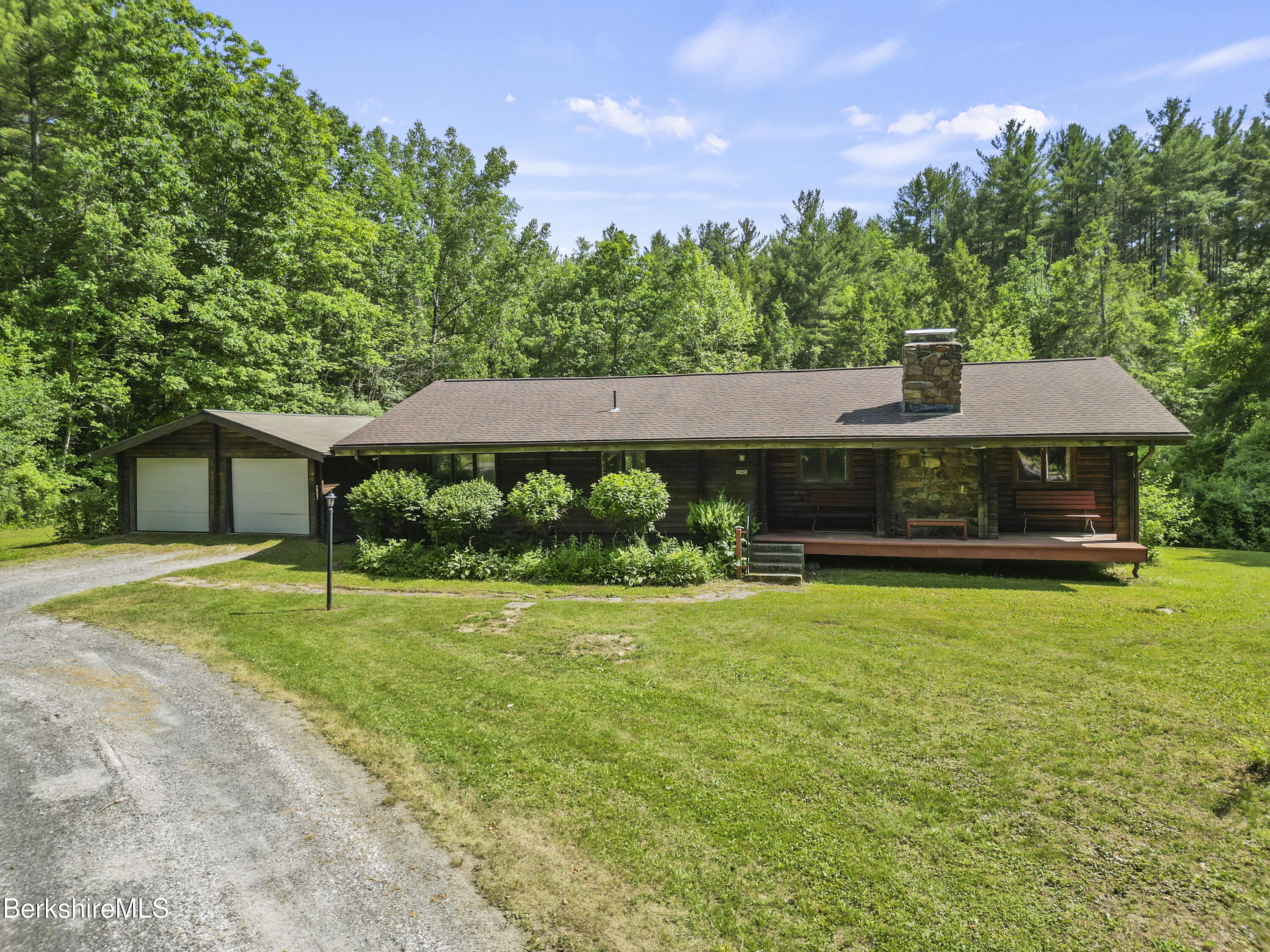 240 Kirchner Road Dalton, MA 01226 - Photo 45 of 51 a front view of a house with a yard and garage