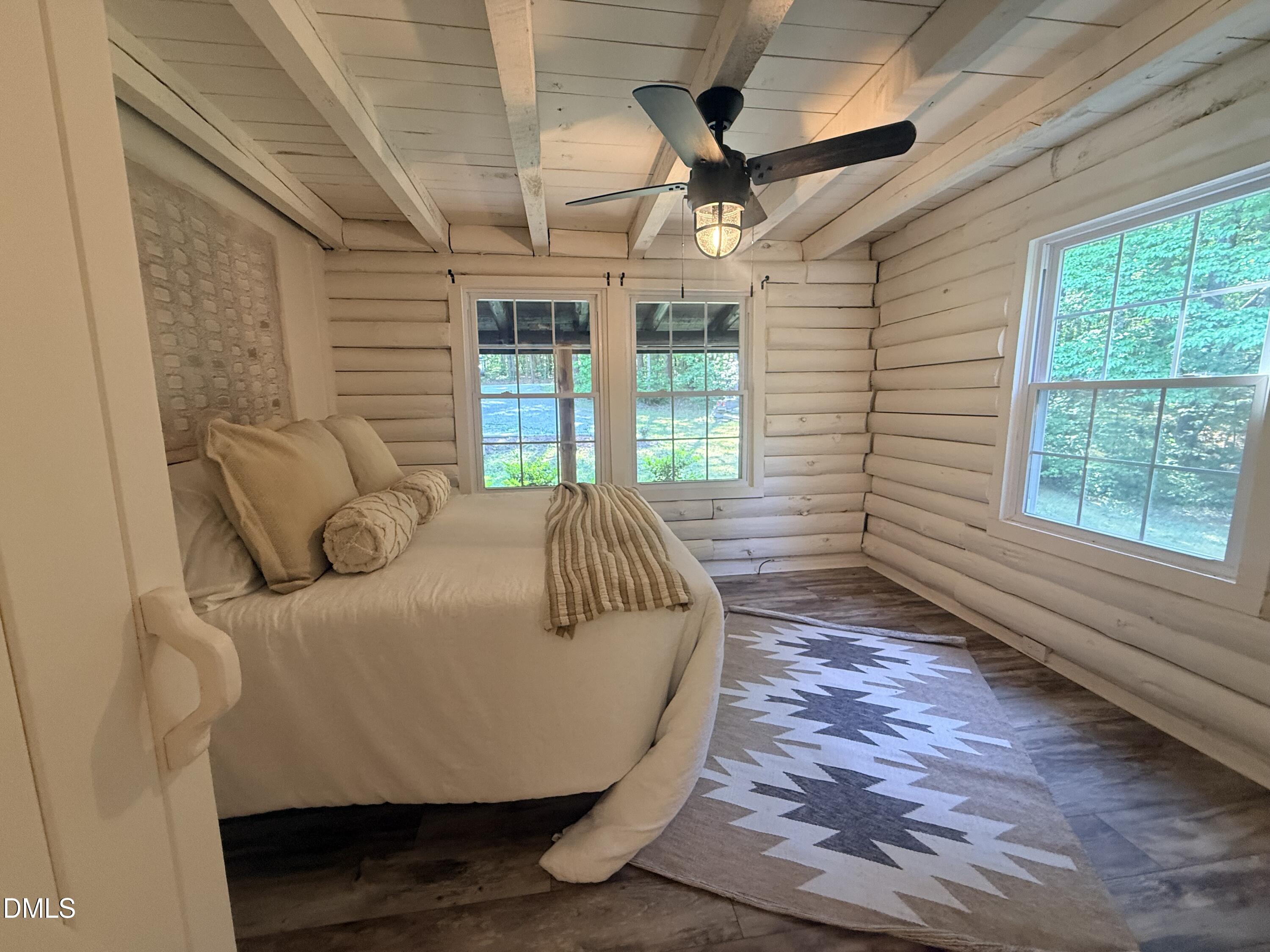 327 Shady Oak Road Roxboro, NC 27574 - Photo 29 of 62 a spacious bedroom with a bed and a large window