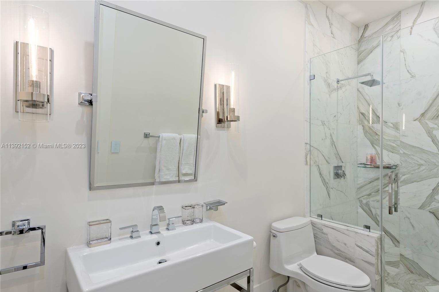 2575 Pine Tree Drive Miami Beach, FL 33140 - Photo 14 of 37 a bathroom with a sink toilet and shower