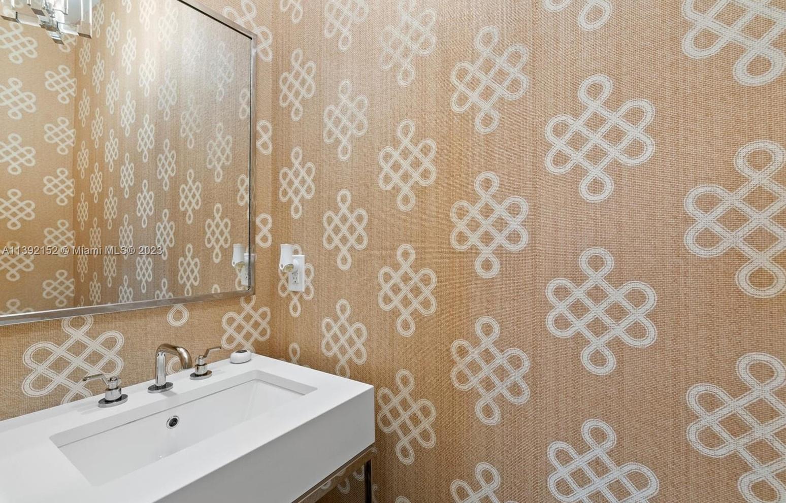 2575 Pine Tree Drive Miami Beach, FL 33140 - Photo 16 of 37 a bathroom with a sink and a mirror