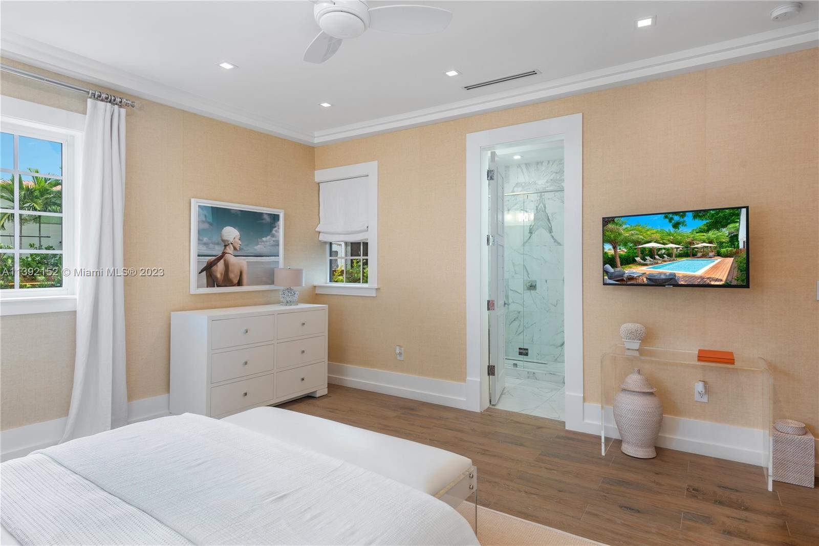 2575 Pine Tree Drive Miami Beach, FL 33140 - Photo 17 of 37 a bedroom with a bed and a view of bathroom