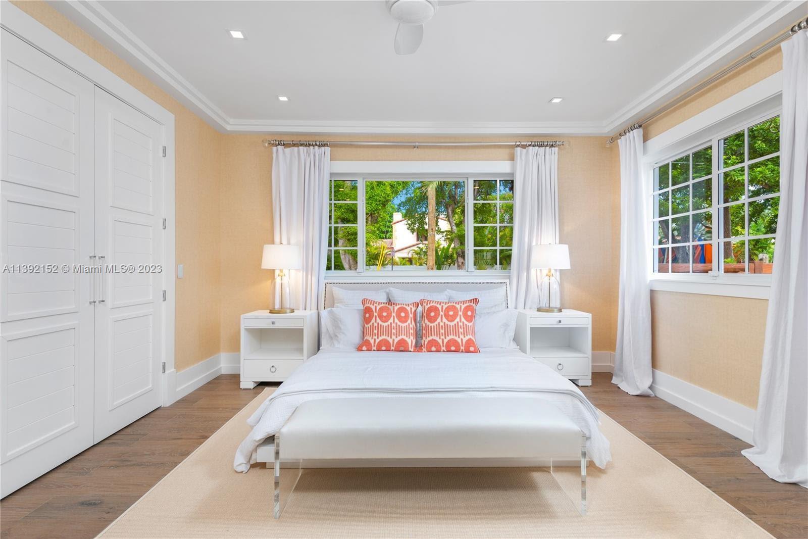 2575 Pine Tree Drive Miami Beach, FL 33140 - Photo 18 of 37 a bedroom with a bed and a window